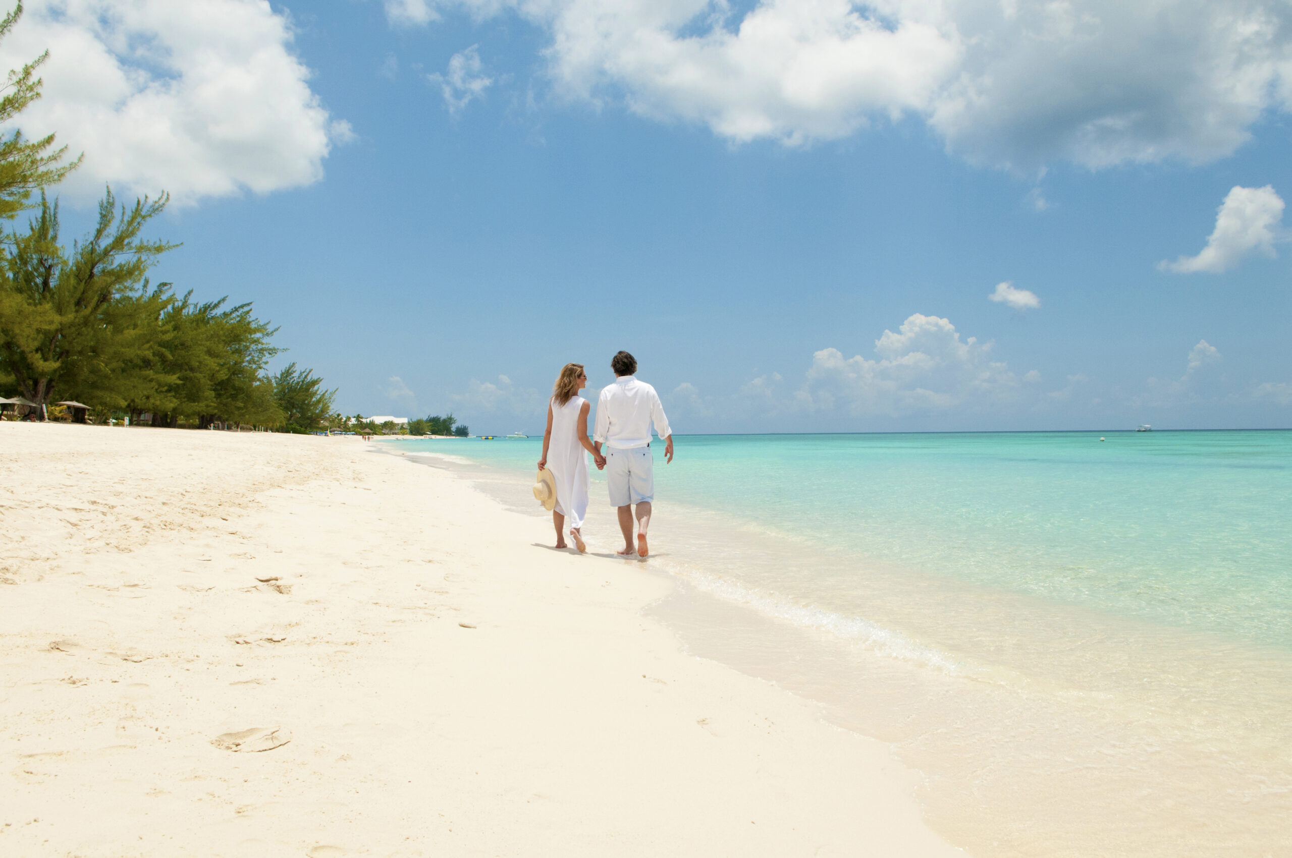 CI-CoupleStrolling7MileBeach-2-MED